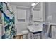 A traditional bathroom with white subway tiles and colorful shower curtain at 1941 Jungle Rd, New Smyrna Beach, FL 32168