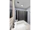 Modern bathroom features a marble vanity top, updated fixtures, and a shower with a gray curtain at 1941 Jungle Rd, New Smyrna Beach, FL 32168