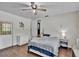 Bedroom showcasing wood floors, ceiling fan, and access to the outside at 1941 Jungle Rd, New Smyrna Beach, FL 32168