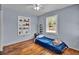 Cozy bedroom with hardwood floors, a bright window, and built-in shelving at 1941 Jungle Rd, New Smyrna Beach, FL 32168