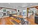 Bright dining area with an open layout, rustic wood table, and seamless flow to the kitchen at 1941 Jungle Rd, New Smyrna Beach, FL 32168