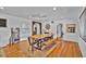 Open dining room featuring a rustic wood table, hardwood floors, and natural light at 1941 Jungle Rd, New Smyrna Beach, FL 32168