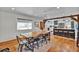 Inviting dining space with wood floors, natural light, and a view into the modern kitchen at 1941 Jungle Rd, New Smyrna Beach, FL 32168
