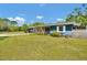 Attractive home featuring a front lawn, driveway, blue siding and a covered front porch at 1941 Jungle Rd, New Smyrna Beach, FL 32168