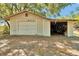 Exterior view of detached garage featuring a large roll-up door at 1941 Jungle Rd, New Smyrna Beach, FL 32168