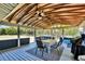 Open air patio with a dining set and a view of the surrounding greenery at 1941 Jungle Rd, New Smyrna Beach, FL 32168