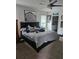 Bright bedroom with a comfortable bed, large artwork, and a view of the kitchen area at 209 Meghan Cir, Deland, FL 32724