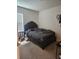 Cozy bedroom featuring a comfortable bed, soft carpet, and natural light from a window at 209 Meghan Cir, Deland, FL 32724