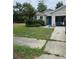 Charming home with a well-maintained lawn and a blue front door at 209 Meghan Cir, Deland, FL 32724