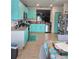 Vibrant kitchen featuring unique colored cabinets, stainless steel appliances, and granite countertops at 209 Meghan Cir, Deland, FL 32724