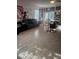 Spacious living room with tile floors, a comfortable sofa, and natural light from the windows at 209 Meghan Cir, Deland, FL 32724