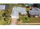 Aerial shot displays a well-kept home with a landscaped lawn, driveway, and attached garage at 219 Lynnhurst Dr, Ormond Beach, FL 32176