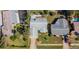 Aerial view of a home showcasing mature trees, a private driveway, and verdant lawn at 219 Lynnhurst Dr, Ormond Beach, FL 32176