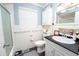 The bathroom has a bath/shower, toilet, and sink with a black countertop at 219 Lynnhurst Dr, Ormond Beach, FL 32176