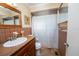 Bathroom featuring brown tiled walls and flooring, vanity, and shower at 219 Lynnhurst Dr, Ormond Beach, FL 32176
