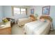 Bright bedroom showcasing two beds, a window, and charming decor at 219 Lynnhurst Dr, Ormond Beach, FL 32176