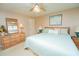 Bright bedroom features a ceiling fan, ample natural light, and comfortable furnishings at 219 Lynnhurst Dr, Ormond Beach, FL 32176