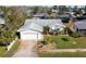 Inviting home featuring a well-manicured lawn, palm trees, and an attached two-car garage at 219 Lynnhurst Dr, Ormond Beach, FL 32176