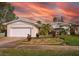 Charming home with lush landscaping, mature palms, and a well-manicured lawn at 219 Lynnhurst Dr, Ormond Beach, FL 32176