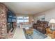 Comfortable living room with a brick fireplace, large TV, and cozy seating area at 219 Lynnhurst Dr, Ormond Beach, FL 32176