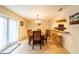Bright dining area with table and chairs next to a view to the kitchen and a set of glass doors at 2309 6Th Ave, Deland, FL 32724
