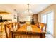 Open dining area with chandelier lighting, access to the kitchen, and a view into the living room at 2309 6Th Ave, Deland, FL 32724
