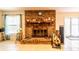 Classic brick fireplace with a wooden mantel and a set of glass doors, next to a sunny window at 2309 6Th Ave, Deland, FL 32724