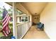 Inviting covered front porch with chairs and a brick floor offering a relaxing outdoor space at 2309 6Th Ave, Deland, FL 32724