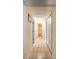 Hallway with tile flooring leads to various rooms, with closet doors for extra storage at 2309 6Th Ave, Deland, FL 32724