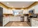 Bright kitchen features white cabinets, stainless steel appliances, and a view into the adjacent dining area at 2309 6Th Ave, Deland, FL 32724