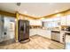 Open kitchen with white cabinets, stainless steel appliances and view to the dining area at 2309 6Th Ave, Deland, FL 32724