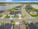 A serene aerial view of a neighborhood showcases homes by a lake and a playground at 234 Mosaic Blvd, Daytona Beach, FL 32124
