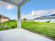 A spacious, well-maintained backyard and patio view features a lush lawn and landscaping at 234 Mosaic Blvd, Daytona Beach, FL 32124