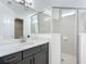 Bathroom featuring a glass-enclosed shower, large mirror, and gray vanity at 234 Mosaic Blvd, Daytona Beach, FL 32124