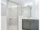Bright bathroom with glass-enclosed shower and gray vanity at 234 Mosaic Blvd, Daytona Beach, FL 32124