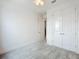 Carpeted bedroom with double closet, ceiling fan, and entry to a bathroom at 234 Mosaic Blvd, Daytona Beach, FL 32124