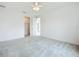 Bright bedroom with ceiling fan, closet, and doorway leading to an ensuite bathroom at 234 Mosaic Blvd, Daytona Beach, FL 32124
