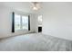 Bright bedroom with carpet, ceiling fan, and a view of the neighborhood at 234 Mosaic Blvd, Daytona Beach, FL 32124