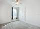 Bright, carpeted bedroom with a ceiling fan and a view of the outdoors at 234 Mosaic Blvd, Daytona Beach, FL 32124