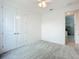 Bright carpeted bedroom with a ceiling fan, double closet, and ensuite bathroom access at 234 Mosaic Blvd, Daytona Beach, FL 32124