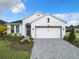 Charming single-Gathering home with a well-manicured lawn, beautiful landscaping, and a two-car garage at 234 Mosaic Blvd, Daytona Beach, FL 32124