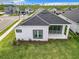 Aerial view of a home with a well-manicured lawn, a concrete patio, and modern design at 234 Mosaic Blvd, Daytona Beach, FL 32124