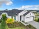 Aerial view of a modern home with a beautiful garden, a paved driveway, and a two-car garage at 234 Mosaic Blvd, Daytona Beach, FL 32124