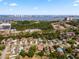 An aerial view captures a suburban neighborhood near a waterfront city skyline, with easy access to parking at 2524 Anastasia Dr, South Daytona, FL 32119