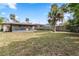 Large backyard features trees and a privacy fence at 2524 Anastasia Dr, South Daytona, FL 32119