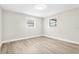 Simple, gray bedroom with wood floors and abundant natural light at 2524 Anastasia Dr, South Daytona, FL 32119