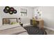 Cozy bedroom featuring modern furniture and decor, with a bed, desk, and circle rug at 2524 Anastasia Dr, South Daytona, FL 32119
