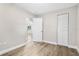 Well-lit bedroom showcasing ample closet space and light wood-look flooring at 2524 Anastasia Dr, South Daytona, FL 32119