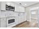 Updated kitchen with white cabinets, modern appliances, and seamless flooring at 2524 Anastasia Dr, South Daytona, FL 32119