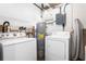 Laundry room with washer, dryer, and a hot water heater at 2524 Anastasia Dr, South Daytona, FL 32119